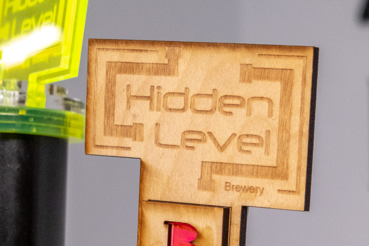 A wooden sign that says hidden level brewery.