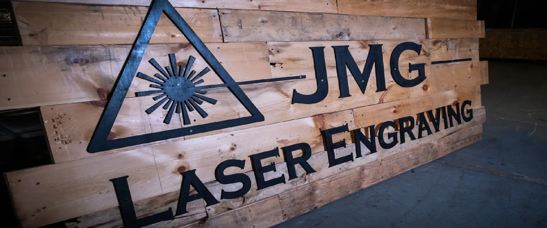 A wooden sign with the words laser engages on it.