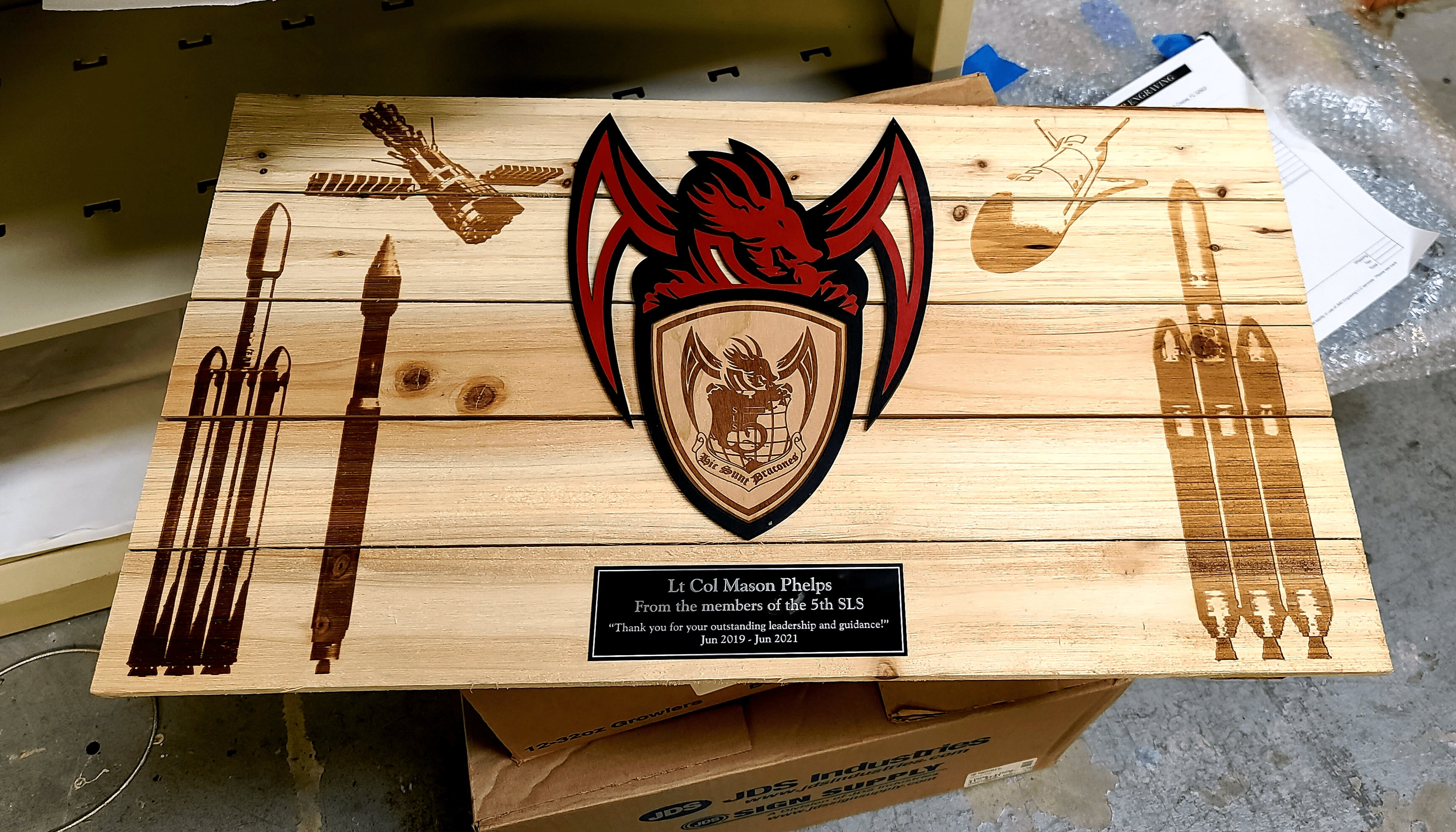 A wooden box with some red and black dragon on it