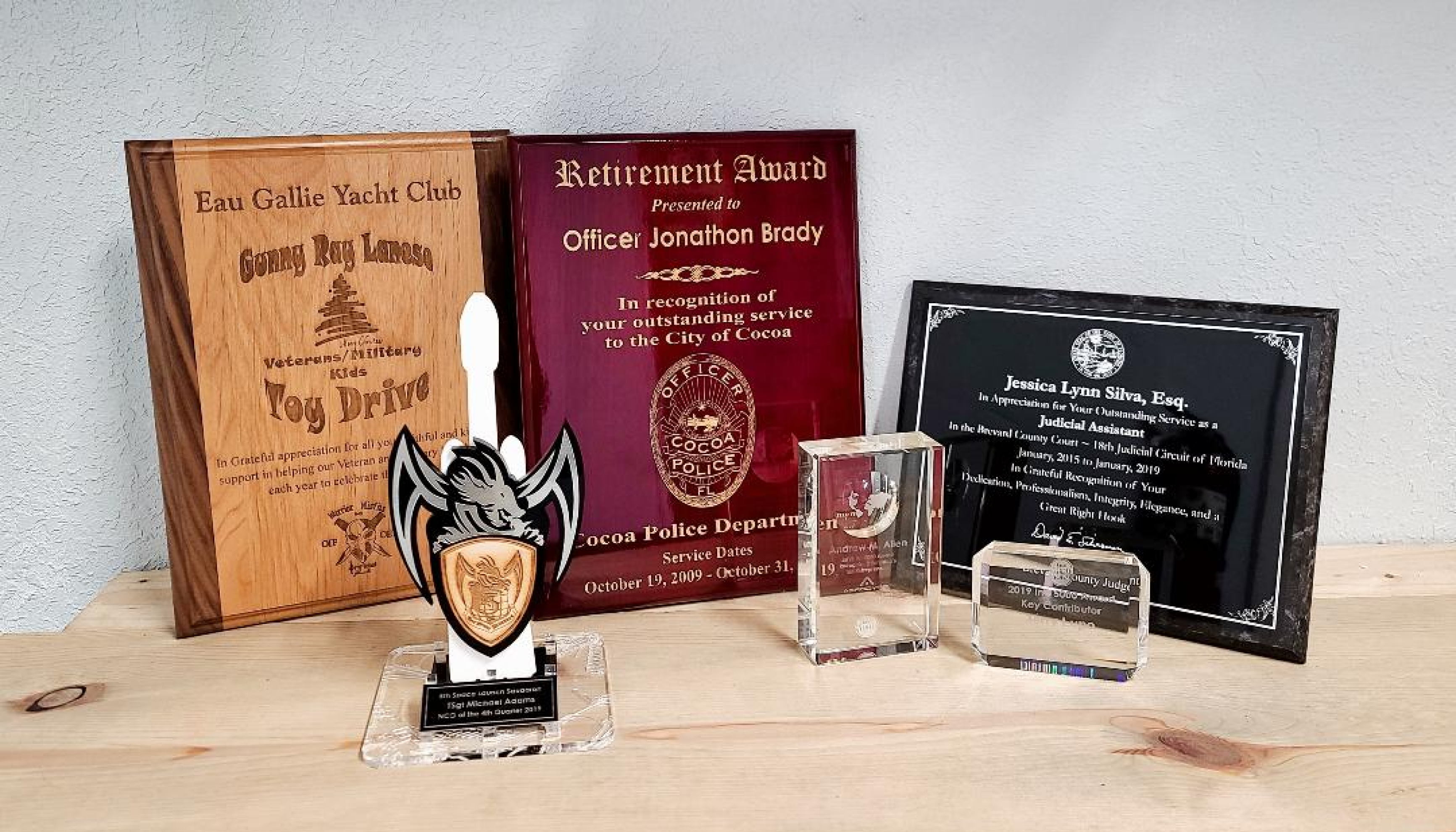 A table with awards and plaques on it.