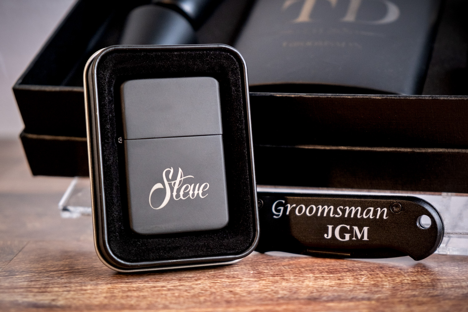 A black zippo lighter sitting on top of a table.