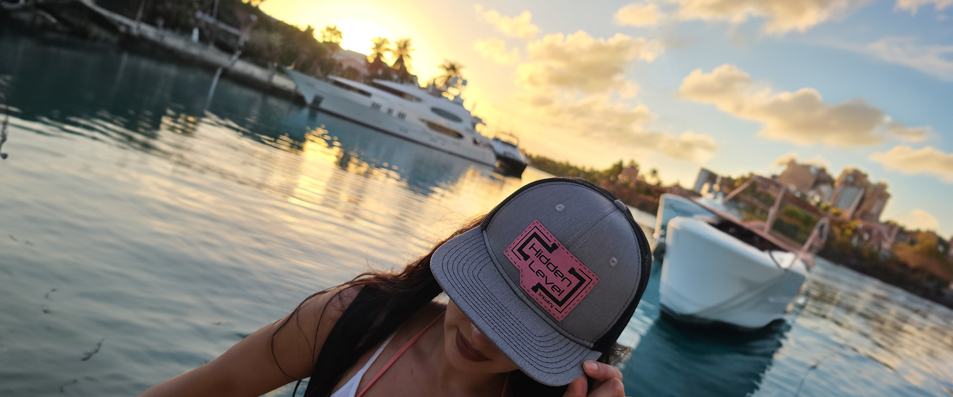 A woman wearing a hat near the water.